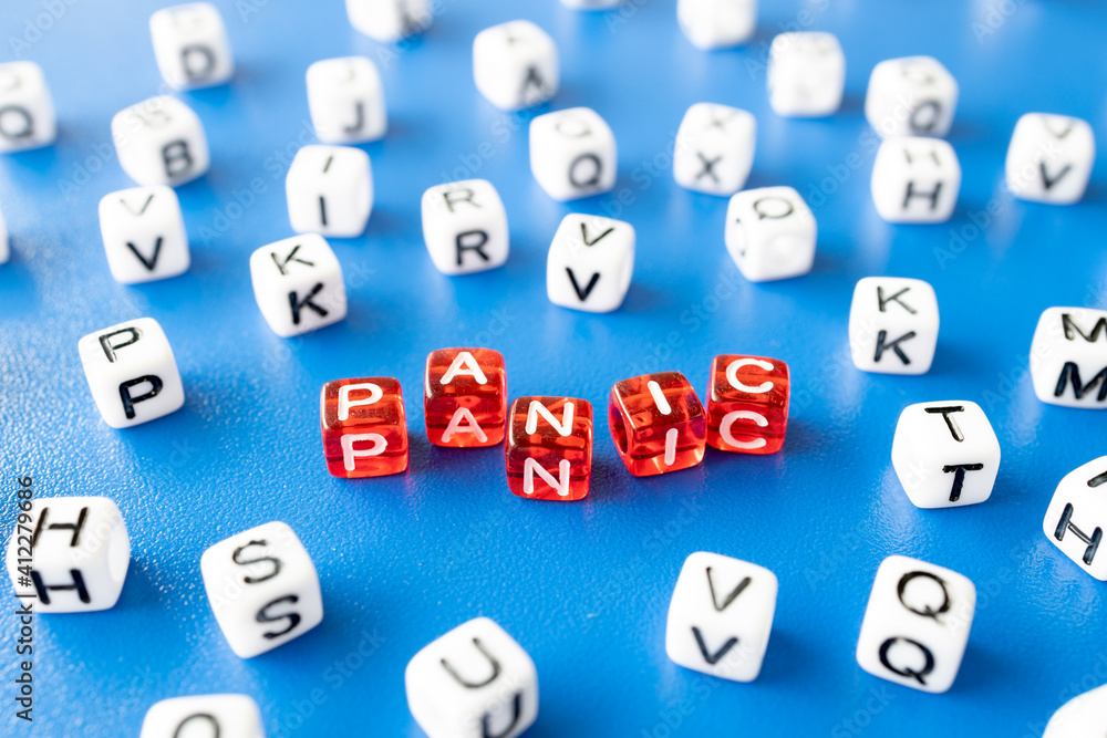 letters on the cubes laid out the word panic, all around the word white cubes with letters letters on the cubes laid out the word panic, all around the word white cubes with letters