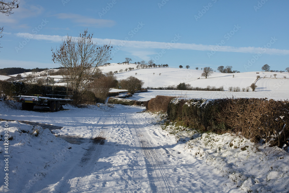British winter scene; Snow covered winter track and snowy landscape in rural Shropshire, UK