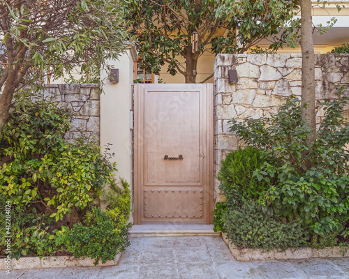 contemporary house entrance metallic door and decorative plants, Athens Greece