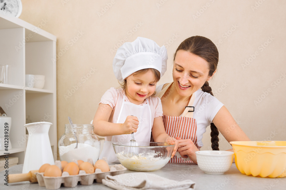 Food blogger mom and her daughter prepare dough, bake pies, enjoy the cooking process in the kitchen Food blogger mom and her daughter prepare dough, bake pies, enjoy the cooking process in the kitchen