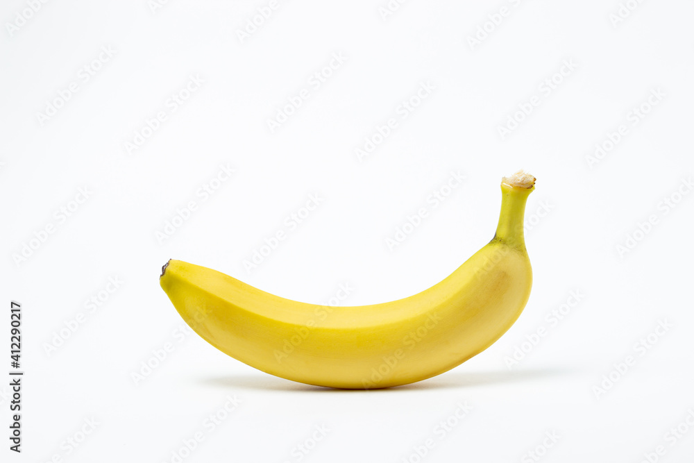 Bananas on a white background. Fresh yellow bananas. One banana in the center of the frame. Exotic fruit Bananas on a white background. Fresh yellow bananas. One banana in the center of the frame. Exotic fruit