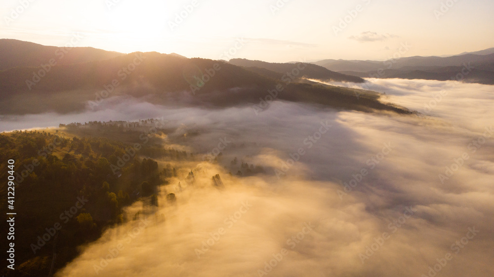 Bird eye aerial view of cloudy foggy mountains landscape view with sunrise Bird eye aerial view of cloudy foggy mountains landscape view with sunrise