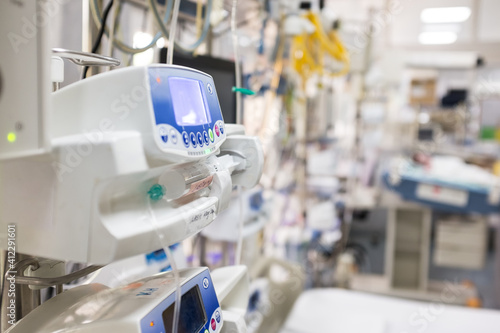 Medical device in UK NHS EMS ICU hospital room,infusion pump dripping intravenous fluid