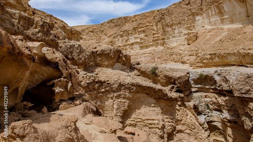 people hiking on a rocky valley on deset.