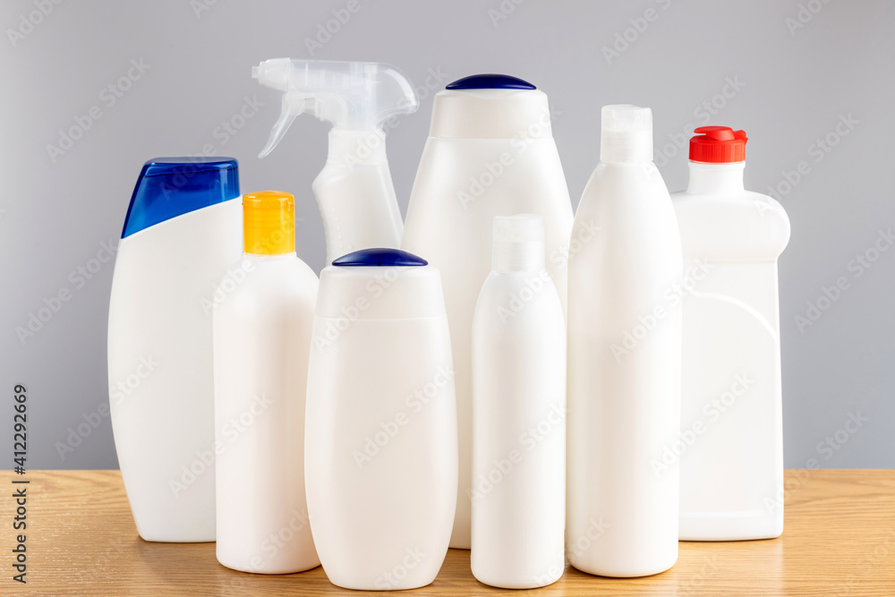 Hair and body cleansers and bathroom and window cleaners. Household chemicals on a gray background. Hair and body cleansers and bathroom and window cleaners. Household chemicals on a gray background.