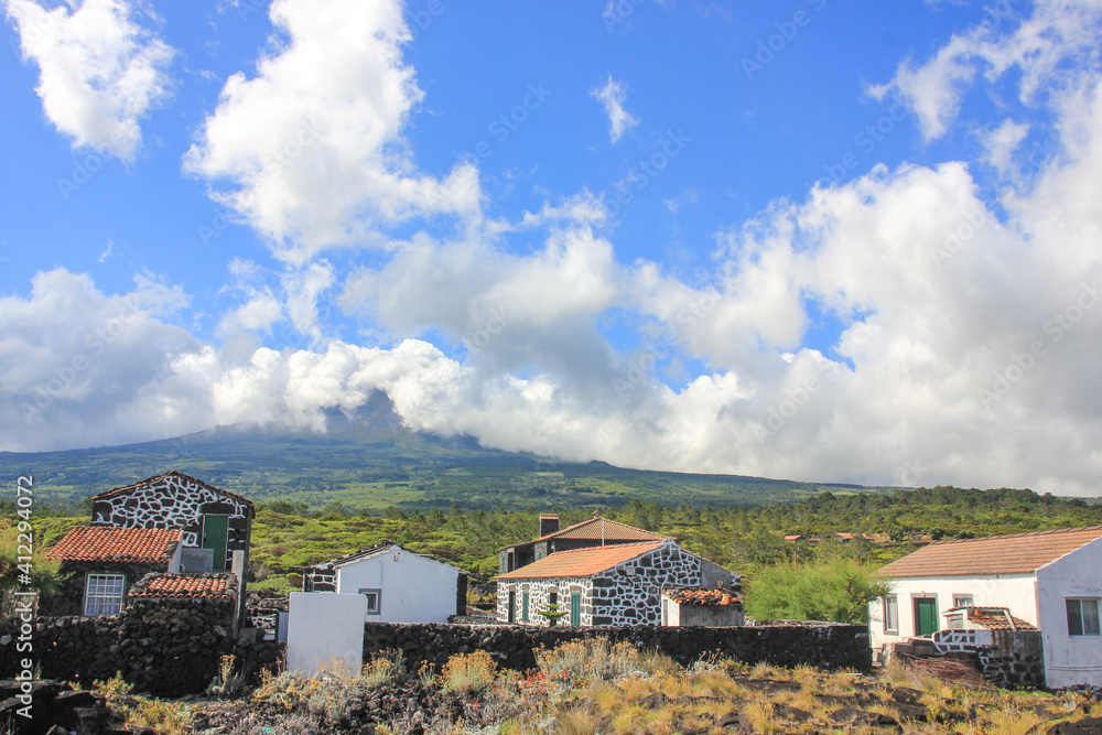 Pico island, view to the mountain with clouds, houses, village, Azores.