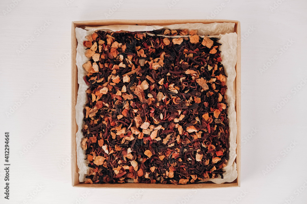Dry fruit tea in a paper box on a white table background. Top view. Copy, empty space for text Dry fruit tea in a paper box on a white table background. Top view. Copy, empty space for text