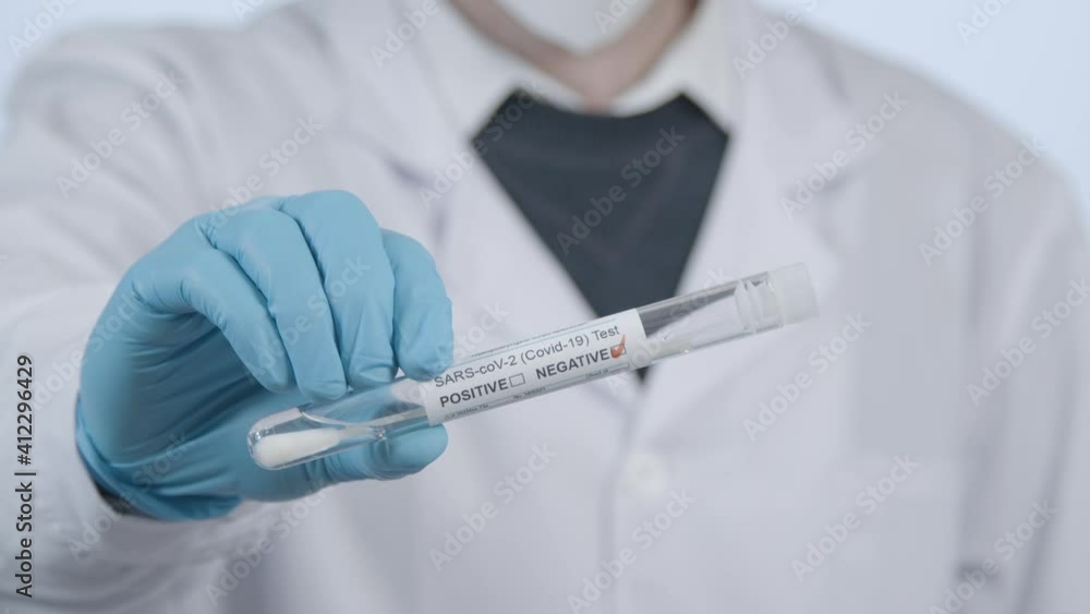 Close Up Shot of Medical Professionals Hand Holding a Negative COVID Test Tube Result Close Up Shot of Medical Professionals Hand Holding a Negative COVID Test Tube Result