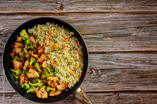 Stir-fry chicken with broccoli in sweet and sour sauce and rice.