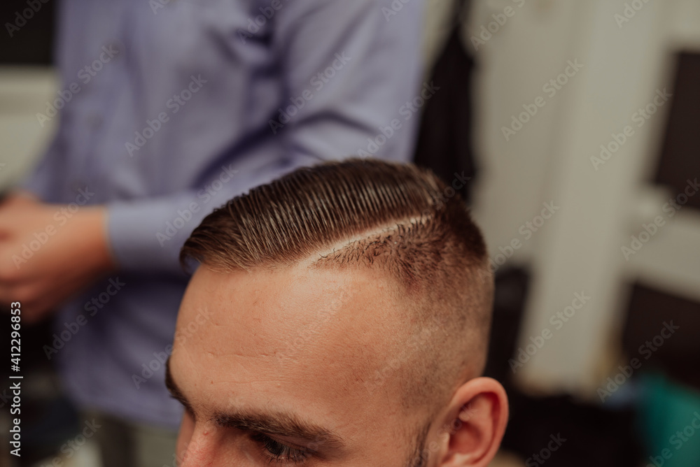 Fototapeta premium Young Man in Barbershop Hair Care Service ConceptYoung Man in Barbershop Hair Care Service Concept