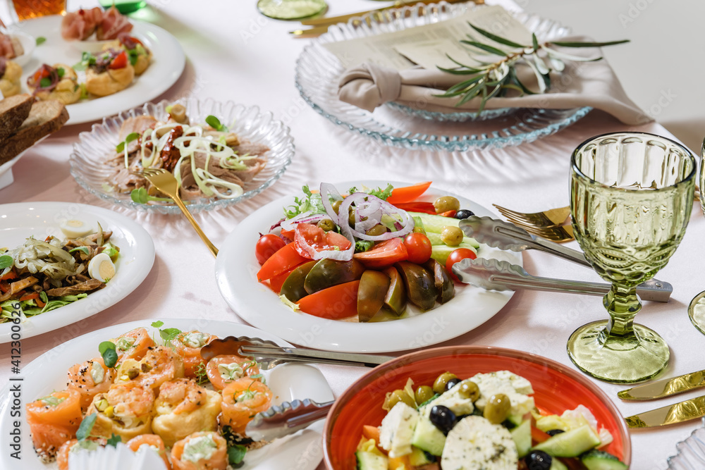 Vegetable salad, tomatoes, cucumbers. The table is lined with dishes. Beautiful dishes, luxury catering. Vegetable salad, tomatoes, cucumbers. The table is lined with dishes. Beautiful dishes, luxury catering.