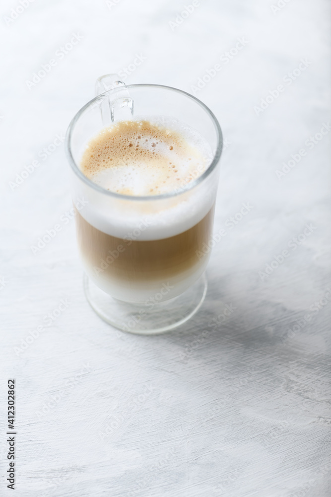 Coffee with milk on bright wooden background. Close up. Copy space. Coffee with milk on bright wooden background. Close up. Copy space.