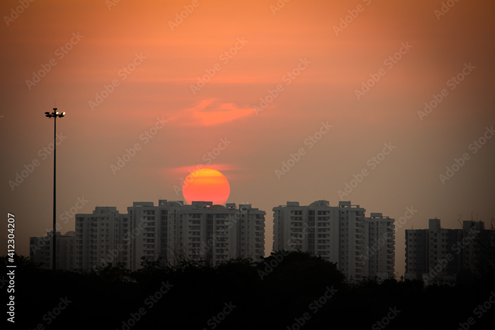 Beautiful view of sunset behind the high rise buildings along the east coast road, chennai, India. 