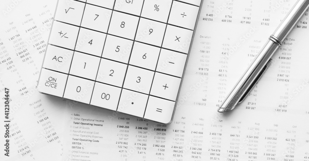 Calculator with pen on financial data. Business and financial research concept. Calculator with pen on financial data. Business and financial research concept.