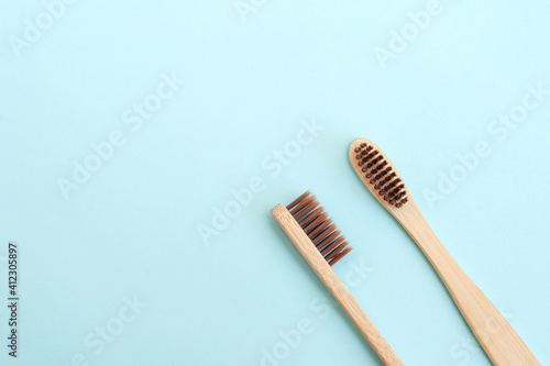 Two bamboo toothbrushes on a blue background. Place for text. Background 
