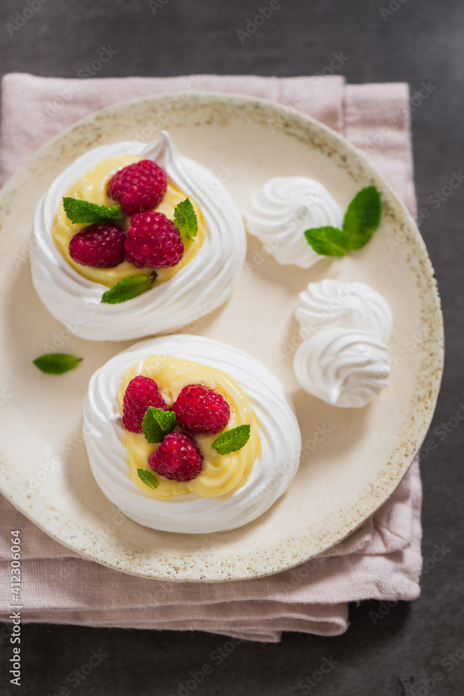 Small pavlova filled with custard cream and raspberries Small pavlova filled with custard cream and raspberries