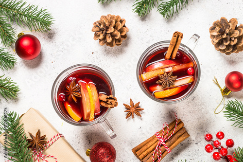 Mulled wine with christmas decorations. Christmas hot drink on white stone table top view.