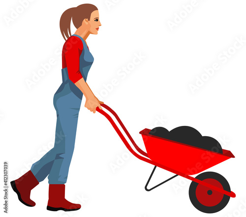 A woman gardener or farmer drives a garden wheelbarrow filled with soil for planting in the garden