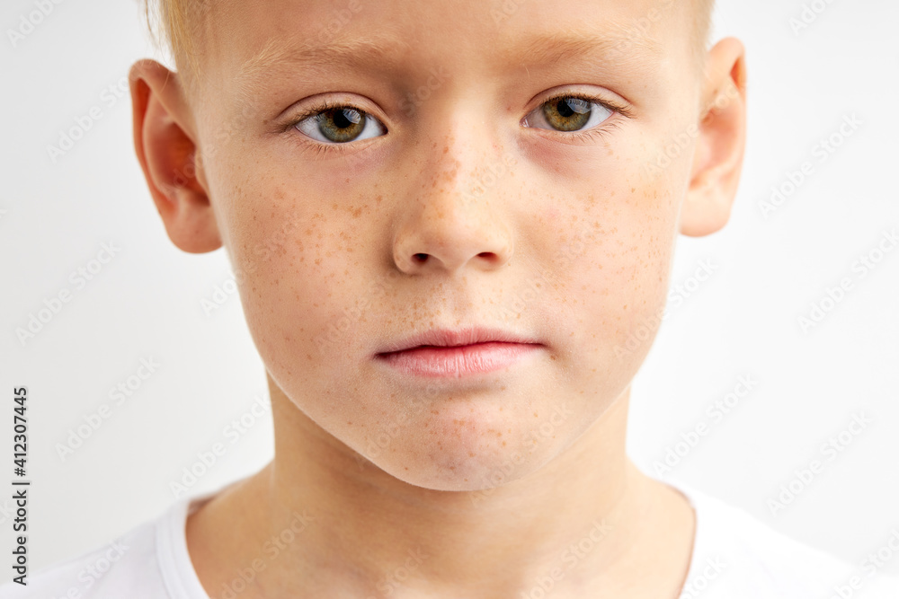 close-up portrait of teenager boy with shy diligent look, having green big eyes, seriously looking at camera isolated over white studio background close-up portrait of teenager boy with shy diligent look, having green big eyes, seriously looking at camera isolated over white studio background