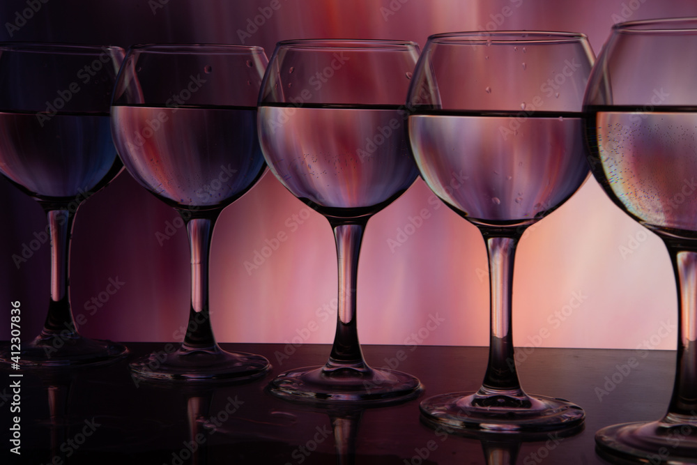glasses of wine in a row on a beautiful background glasses of wine in a row on a beautiful background