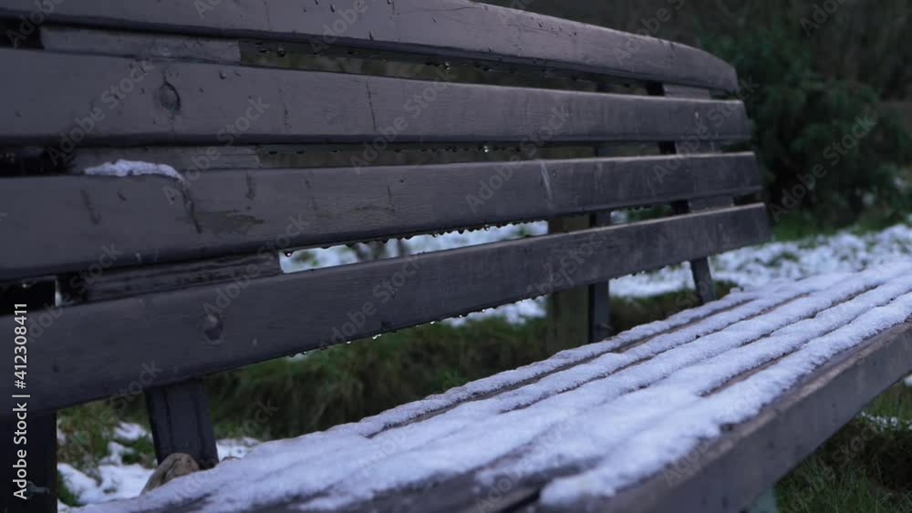 Empty bench in winter covered in snow and ice Empty bench in winter covered in snow and ice