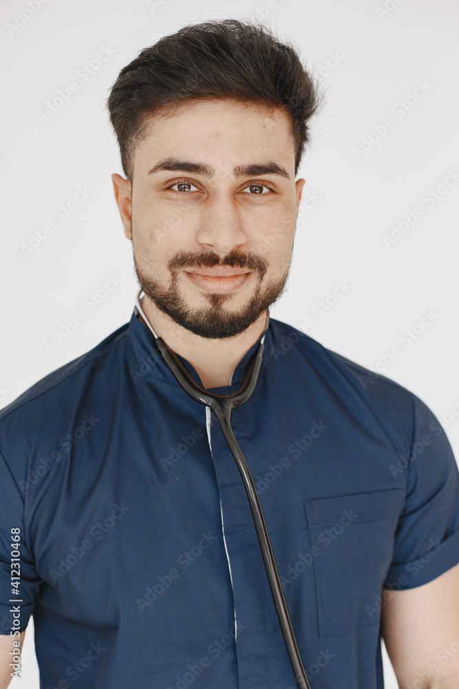Fototapeta premium International medical student. Man in a blue uniform. Doctor with stethoscope.