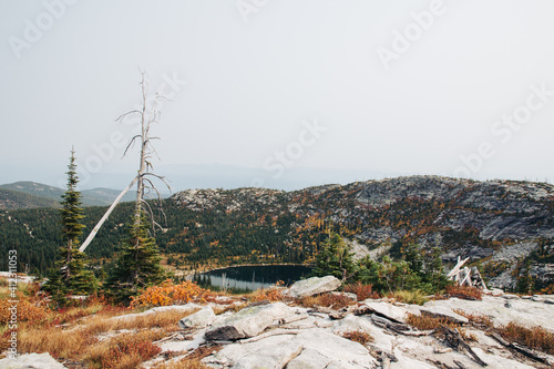 Alpine lake from above on a hazy and smoky afternoon. photo