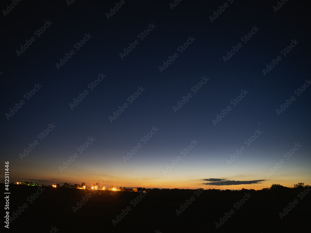 dark night sky, distant lights on the horizon, the sun had just set dark night sky, distant lights on the horizon, the sun had just set