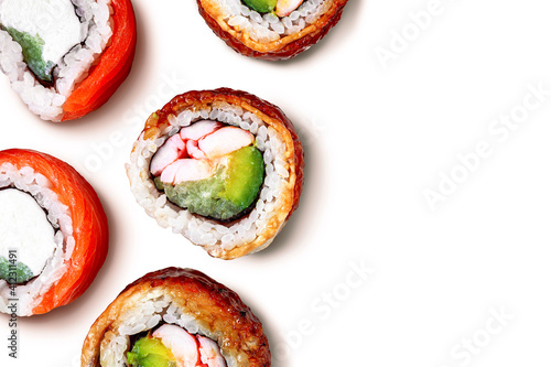 Sushi isolated on white background. Sushi background. Sushi pattern with fresh salmoon and eel rolls on white background. Round folding rolls. Fresh roll pieces