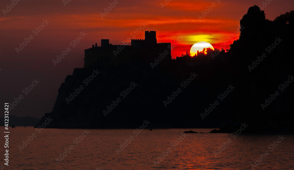 Obraz premium general view of Duino Castle at sunset