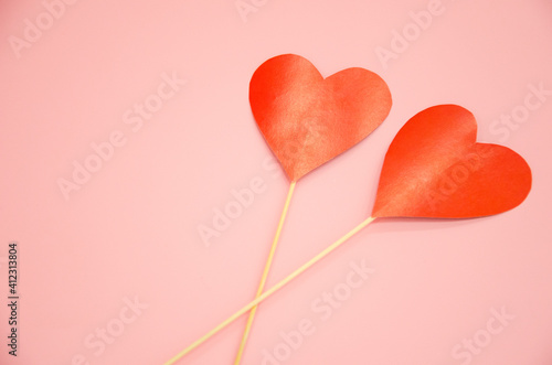 two hearts lie on a pink background. valentine's day concept