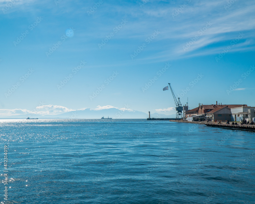 Thessaloniki Greece January 30, 2021: the entrance of the old port and the blue sea with a blue sky is magical and the road that people can enjoy their walk Thessaloniki Greece January 30, 2021: the entrance of the old port and the blue sea with a blue sky is magical and the road that people can enjoy their walk