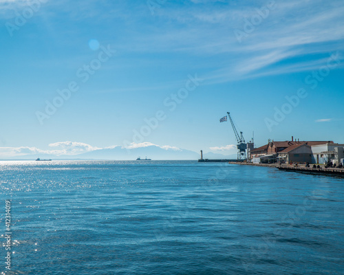 Thessaloniki Greece January 30, 2021: the entrance of the old port and the blue sea with a blue sky is magical and the road that people can enjoy their walk