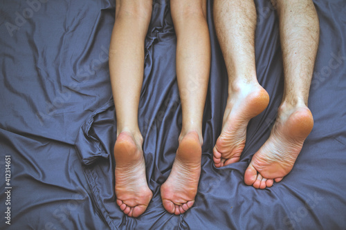 Sensual couple. Couple in love. Legs man and woman. Bedroom. 