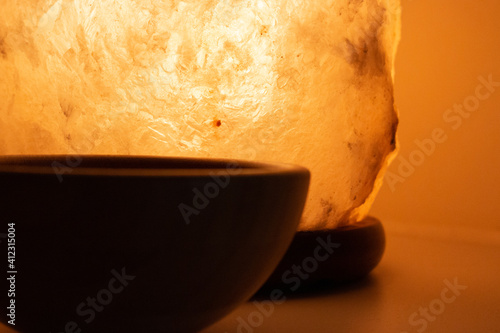 Tibetian singing bowl in cozy interior, witt ceramic pot with succulents, insence for meditation and self care.