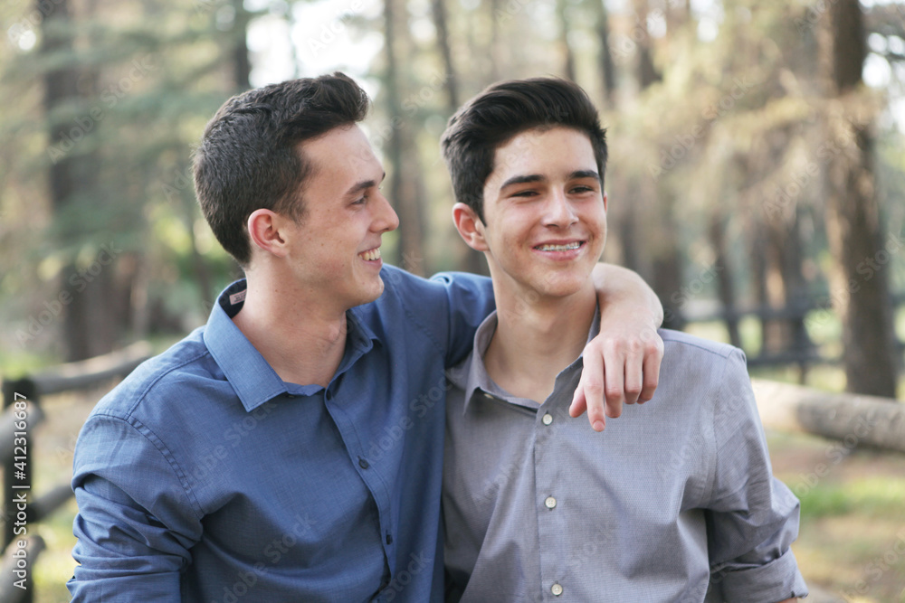 Brothers With Arms Around Eachtother Smiling and Laughing Brothers With Arms Around Eachtother Smiling and Laughing