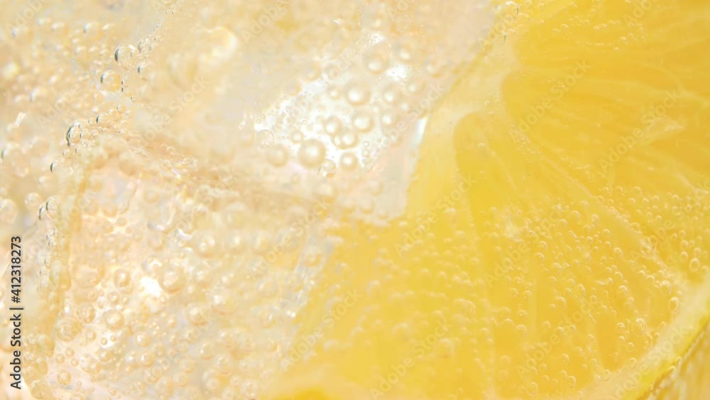 Refreshing soft cold lemonade mojito drink with slices of lemon and sparkling water. 4k resolution, macro shot. High quality 4k footage