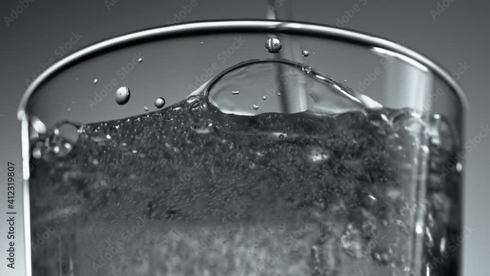 Mineral water is poured into a glass. The sparkling water in the glass bubbles in a slow motion, refreshing the carbonated drink. 4K Mineral water is poured into a glass. The sparkling water in the glass bubbles in a slow motion, refreshing the carbonated drink. 4K