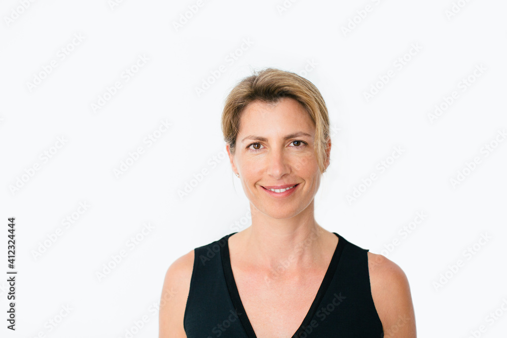 Portrait of a mature blonde woman standing over white. Portrait of a mature blonde woman standing over white.