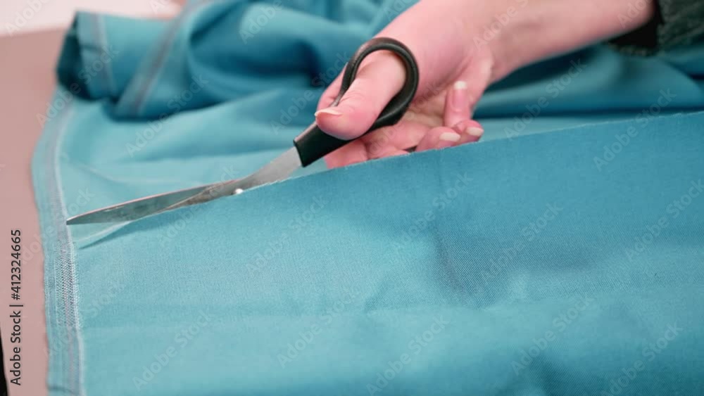 cutting the fabric with sharp scissors. Cut the fabric with tailor's scissors. cutting the fabric with sharp scissors. Cut the fabric with tailor's scissors.