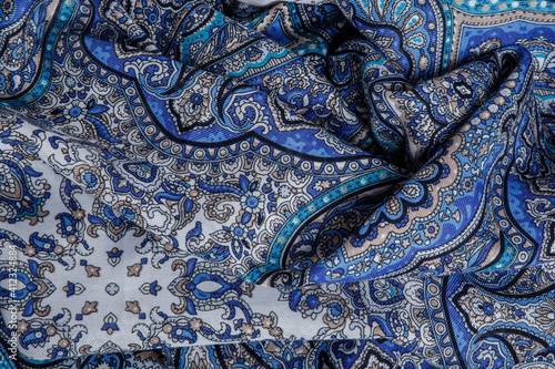 top view at crumpled soft cotton scarf with bright blue oriental ornament