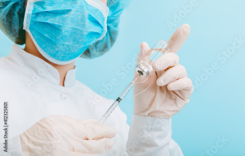 Doctor making vaccination in protective mask and gloves. Covid 19 Vaccine in glass vial bottle and syringe, medicine liquid in doctor hand for injection. Vaccination and immunization