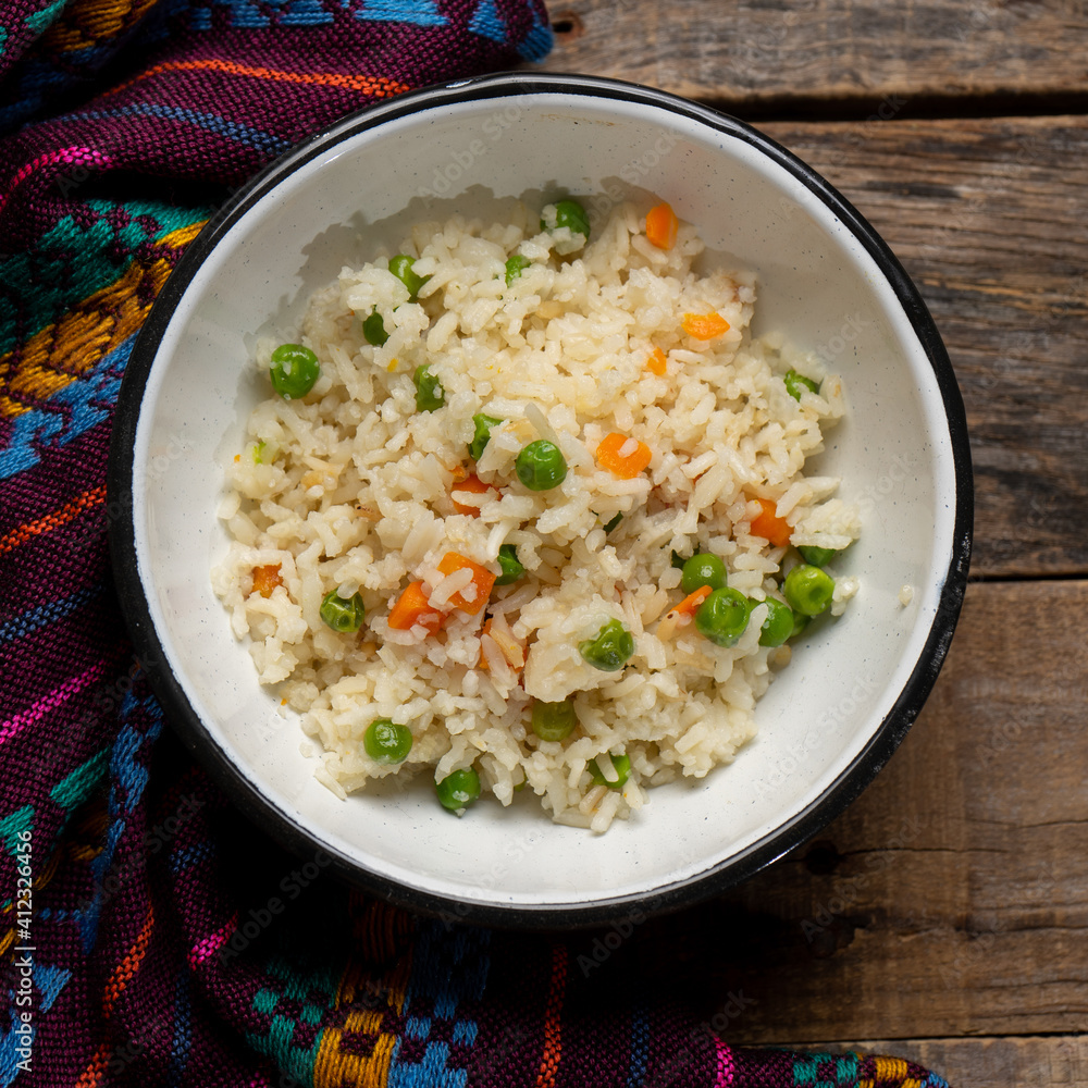 White rice with peas and carrot on wooden White rice with peas and carrot on wooden
