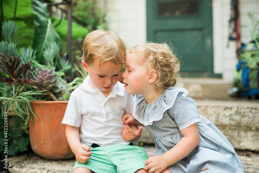 Two young twins playing outside in the summertime Two young twins playing outside in the summertime