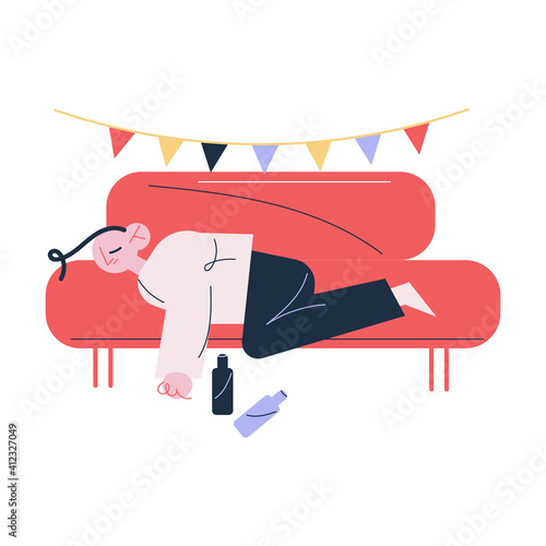 Young man lying on sofa suffering from hangover in morning