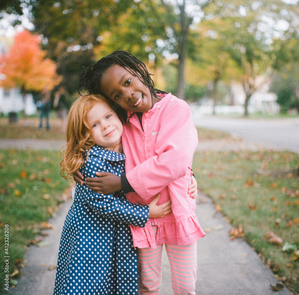 Cute redhead and black friends hugging Cute redhead and black friends hugging