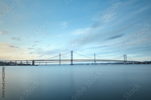 Fototapeta Naklejka Na Ścianę i Meble -  Two bridges against the blue sky, Forth Road Brtidge and Queensferry Crossing, Scotland, United Kingdom