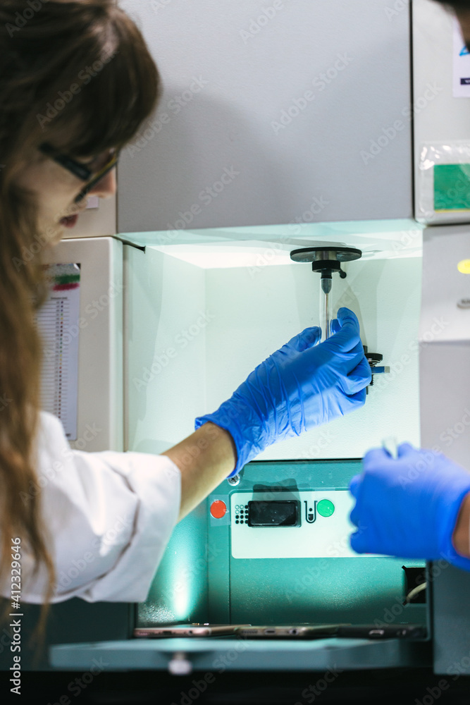Biologist working with centrifuge machine Biologist working with centrifuge machine