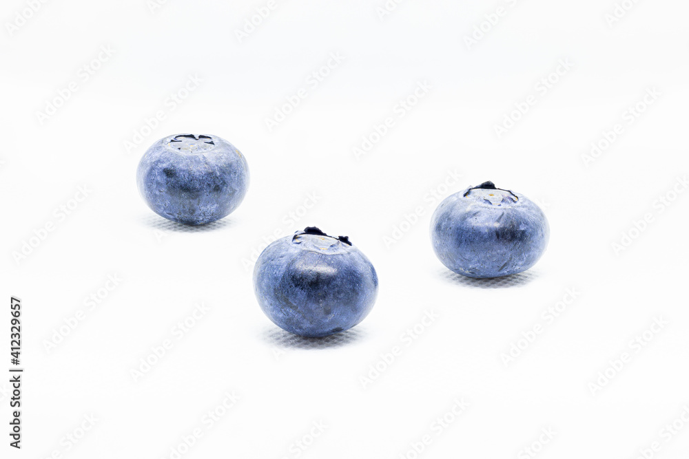 3 isolated blueberries seen from the front on a white background. 3 isolated blueberries seen from the front on a white background.