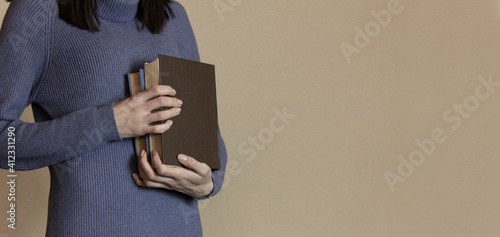 the woman was holding books in her hands